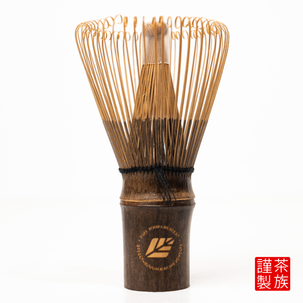 Traditional Japanese tea whisk with wooden handle on a white background