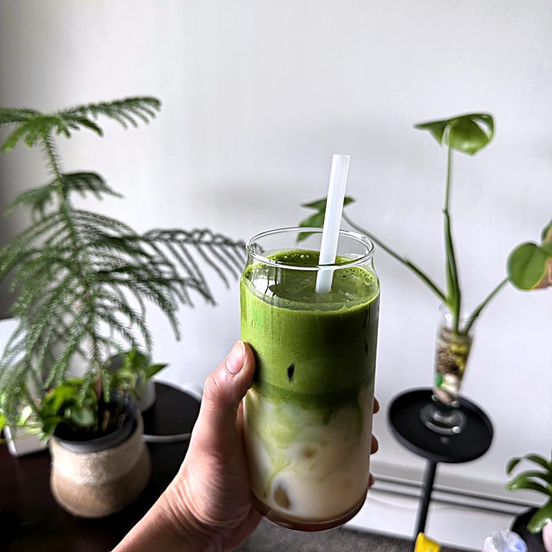 Customer photo: Aesthetic layered latte framed by indoor plants